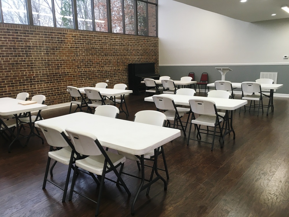 chairs and tables set up in the Harris Gardens Community Center