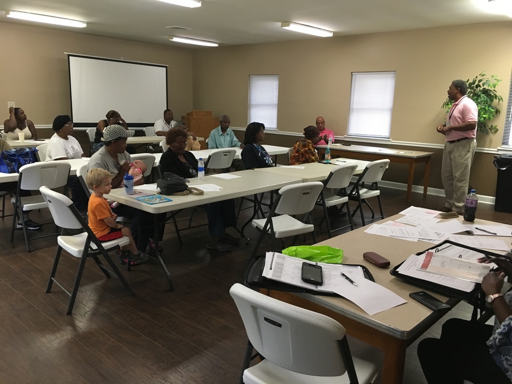 RHA Executive Director Felts Lewis addresses residents in the Lee Gardens Community Center.