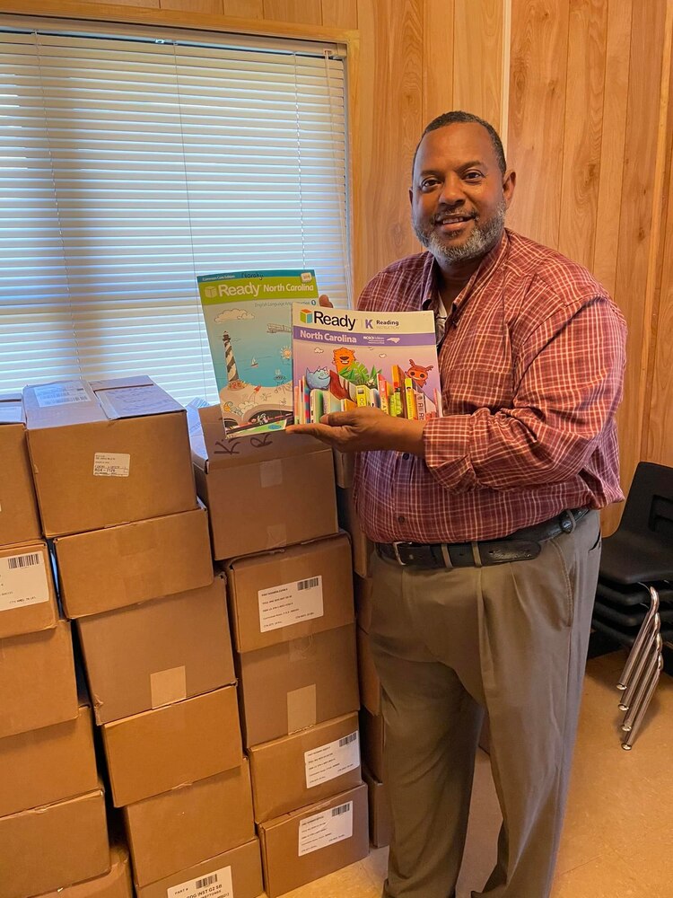 Larry Mayfied Holds Donated Ed Materials.