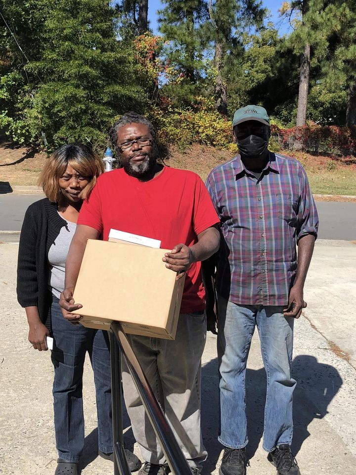 Detric with Mom and Dad Distributing Food Box.