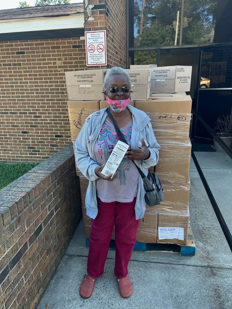 A woman receiving a food box.