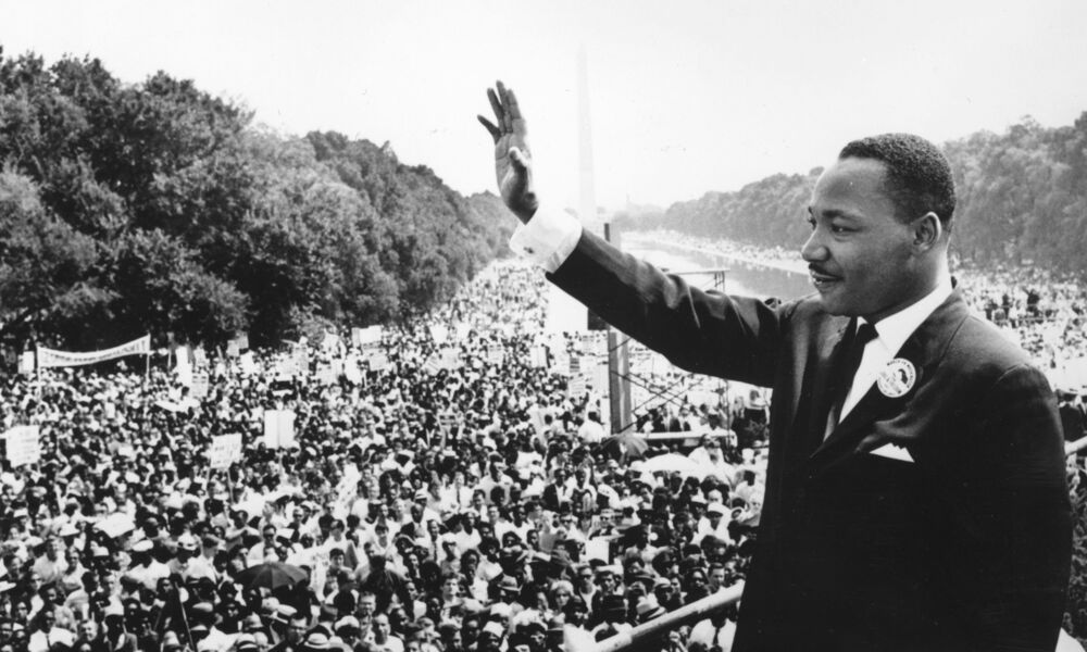 Martin Luther King Jr. standing in front of a crowd.