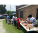 A bunch of people getting hot dogs.