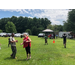 People walking around a field.