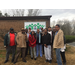 A group of people standing by the Roxboro sign.