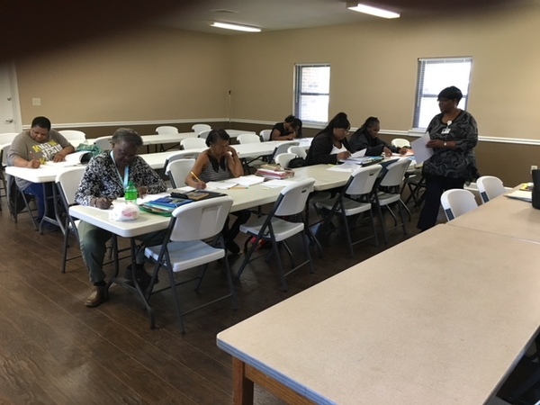 FirstGEDClassatLGCC.jpg Adults taking a test for their continued education.