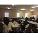 Police officers and community members seated together at tables talking