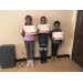 Three children pose with certificates.