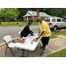 Two people preparing a table.