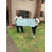 Two people holding a large check.