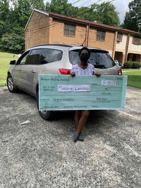 A woman holding a large check.