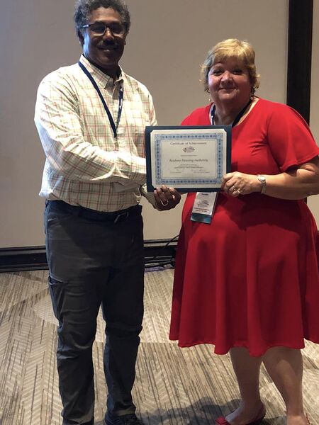 RHA Executive Director Felts Lewis receives Newsletter of the Year and Human Service Awards from Carolinas Council President Connie Howard